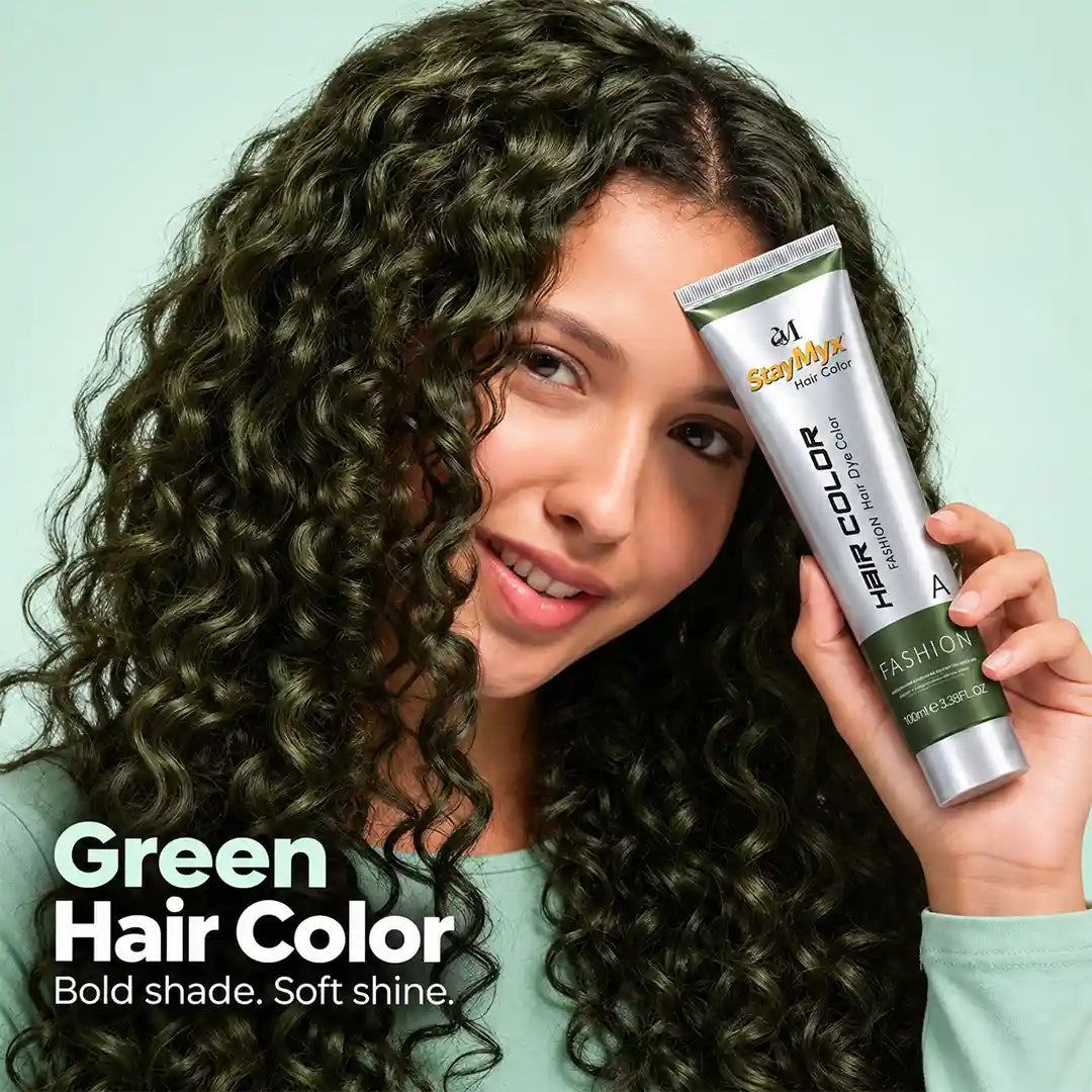Woman with glossy, curly green hair holding StayMyx Green Hair Color tube, showcasing rich green hair dye with a soft, shiny finish.