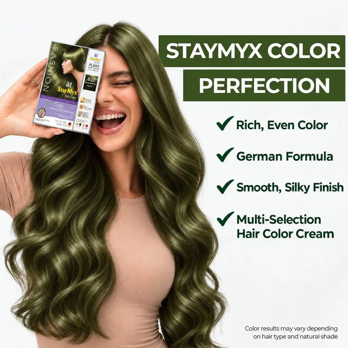 Smiling woman with long, glossy olive green hair holding StayMyx 6/22 hair color cream, featuring German Formula, rich even color, and a smooth silky finish.