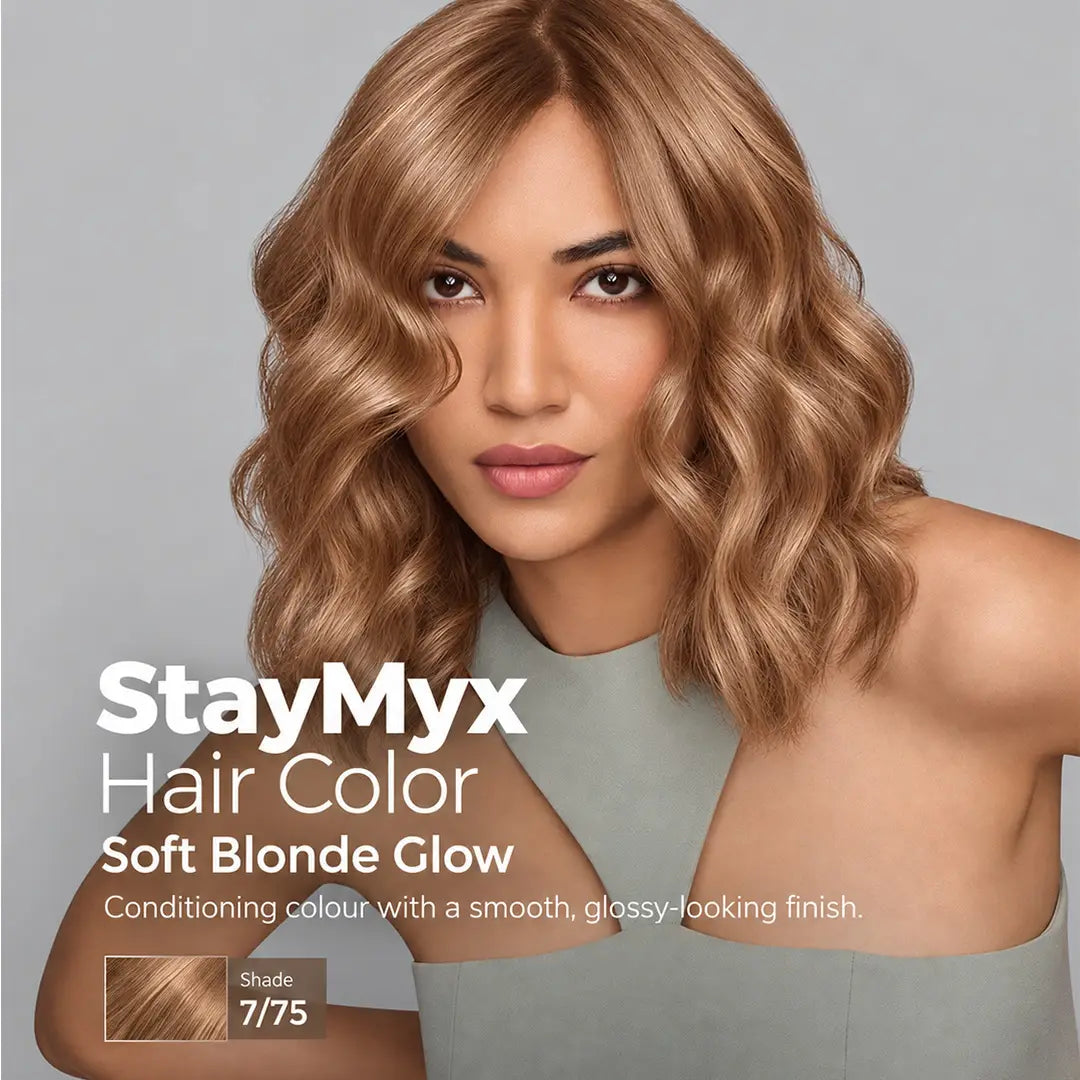 Model with soft, glossy warm blonde wavy hair showcasing StayMyx 7/75 hair color, featuring a warm heather shade and smooth, shiny-looking finish.