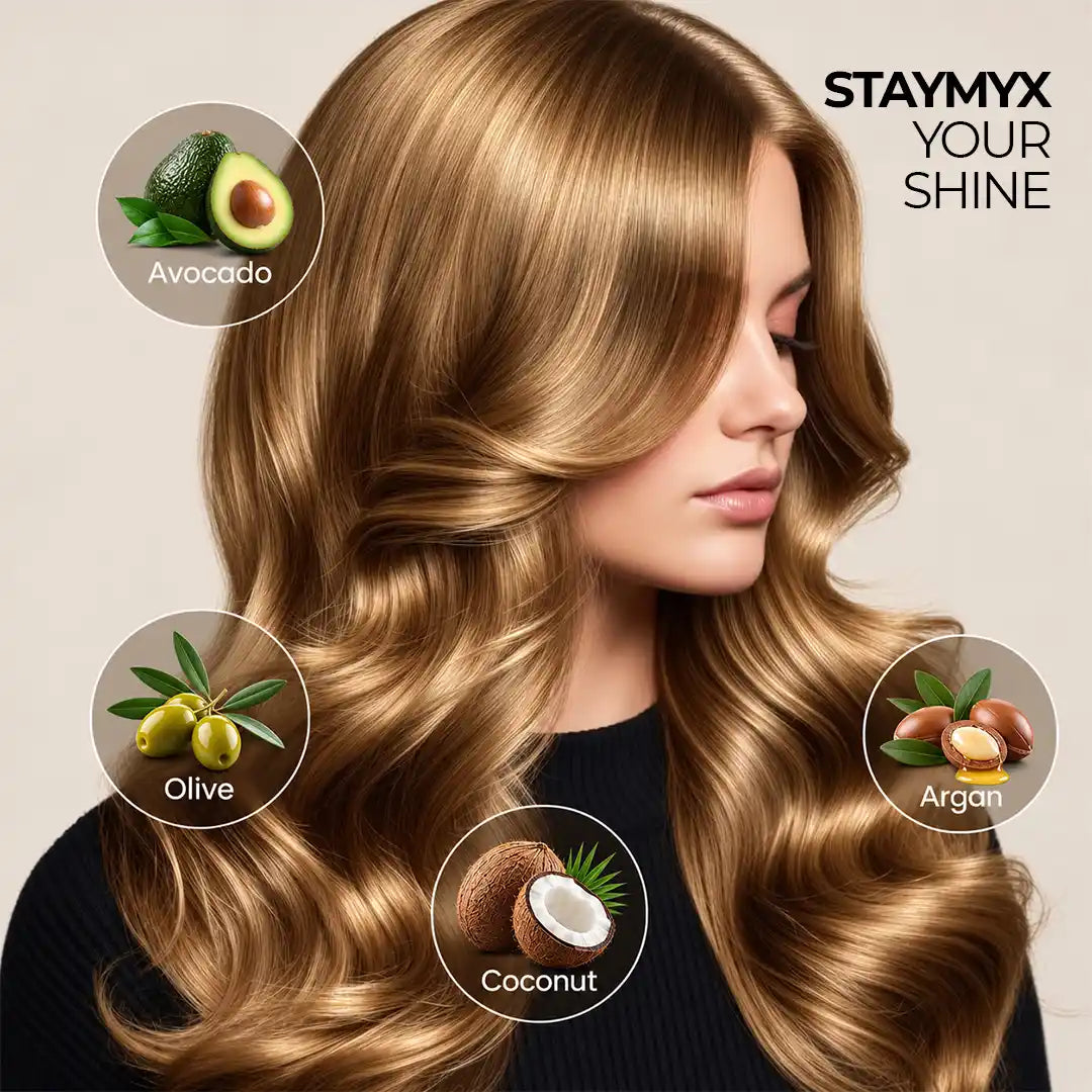 Model with long, glossy golden brown hair in a StayMyx hair color promotional image featuring avocado, olive, coconut and argan oils for hair care.