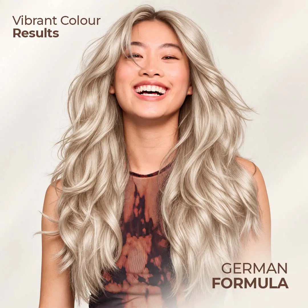 Smiling woman with long, voluminous platinum blonde hair showcasing vibrant blonde hair color results, inspired by StayMyx German Formula hair dye.